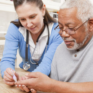 Nurse examining older patient in home